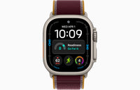 Apple Watch Ultra 4 smartwatch with burgundy Trail Loop strap, natural case.
