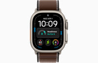 Apple Watch Ultra 4 smartwatch with dark umber Trail Loop strap, natural case front view.