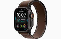 Apple Watch Ultra 4 smartwatch with dark umber Trail Loop strap, natural case and side button.