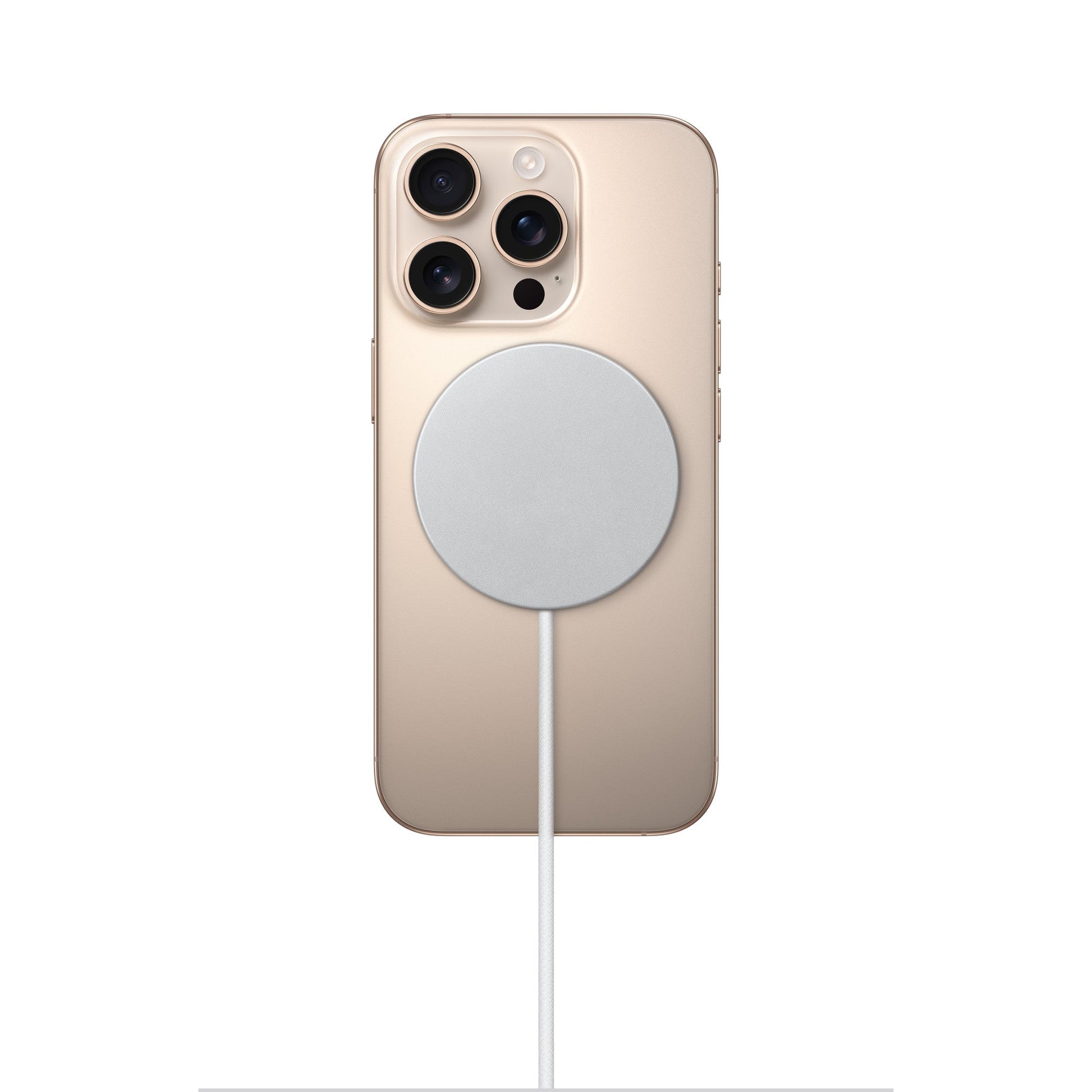MagSafe charger on beige phone back, white puck and charging cable