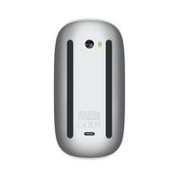 Mouse underside in dark gray with Apple logo, grips, and oval charging port