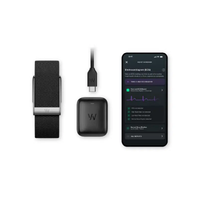 Black fitness tracker band, charging cable, and phone showing fitness app screen.